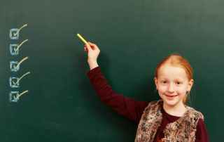 girl pointing to checkboxes on chalkboard for how to qualify a lead